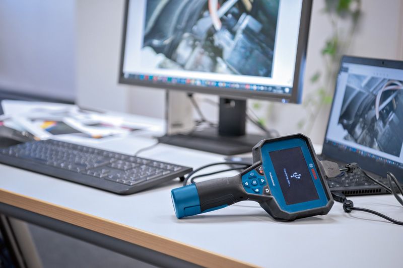 Inspection camera connected to a laptop, images of machinery displayed on monitors.
