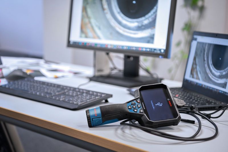 Inspection camera connected to a laptop and monitor on an office desk.