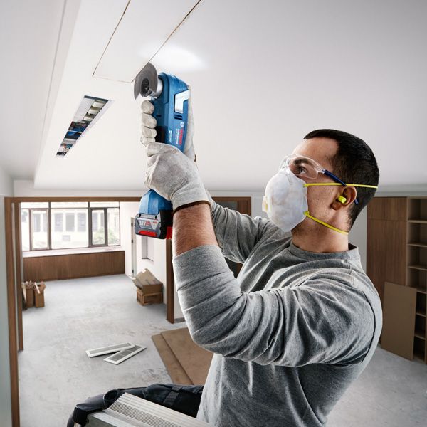 Bosch GOP 18V-28 multitool used for ceiling cutting.
