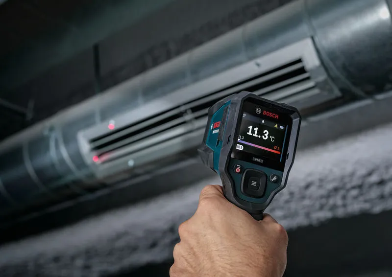 Person using a thermo detector to measure air temperature at an HVAC vent.