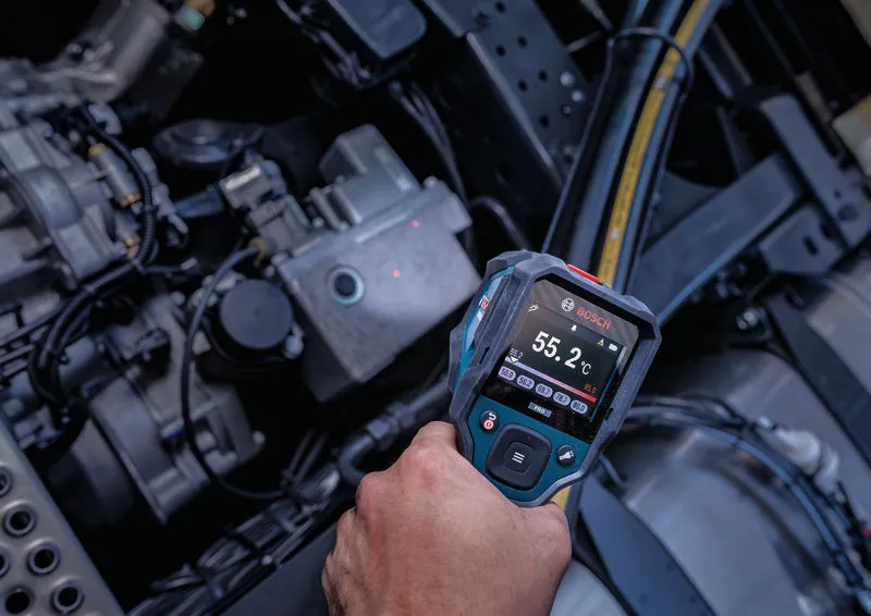 Person uses a thermo detector to check the temperature of machinery parts.
