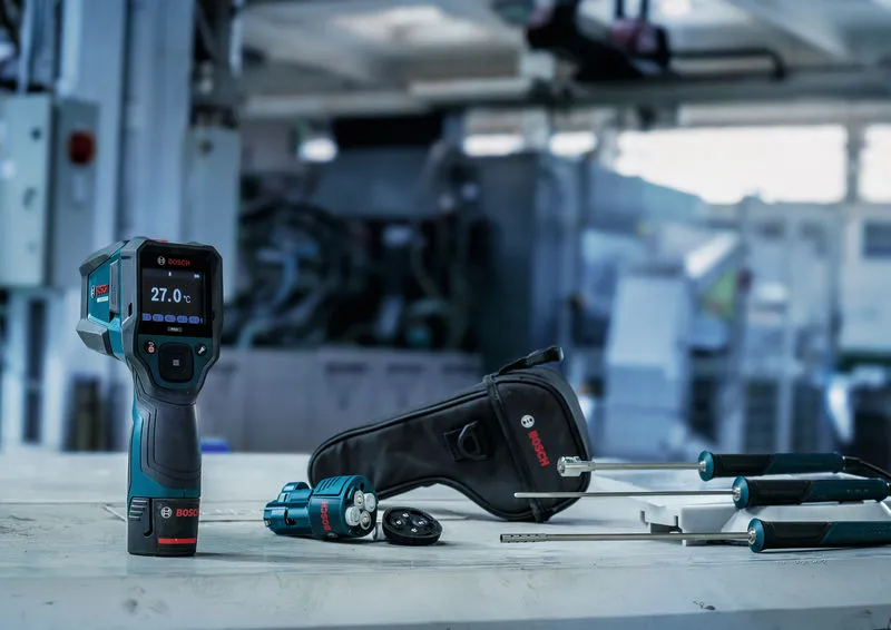 Thermo detector and probes with carrying case on a workbench in an industrial setting.