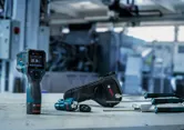 Thermo detector and probes with carrying case on a workbench in an industrial setting.
